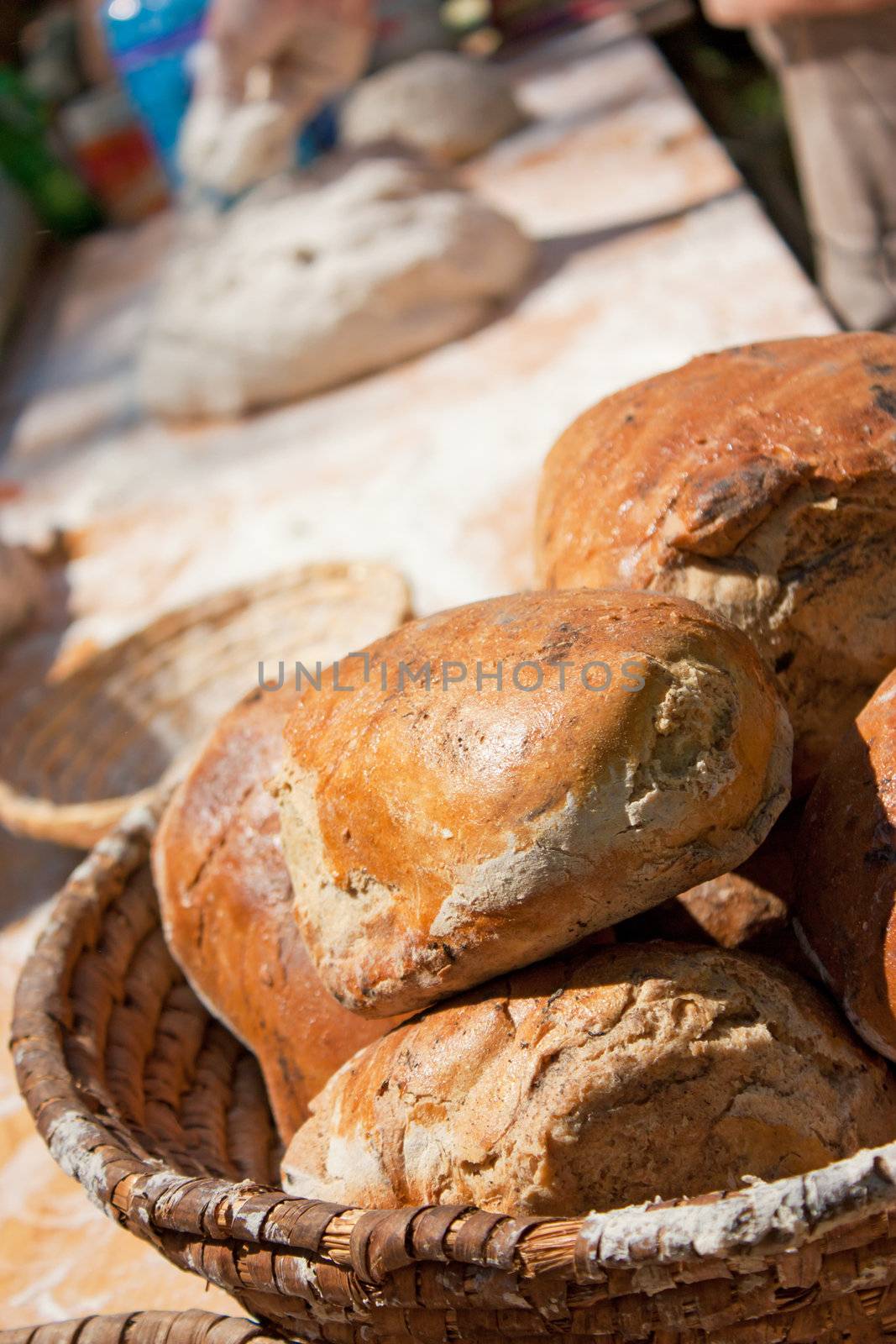 Baker cutting and cooking some bread outdoor