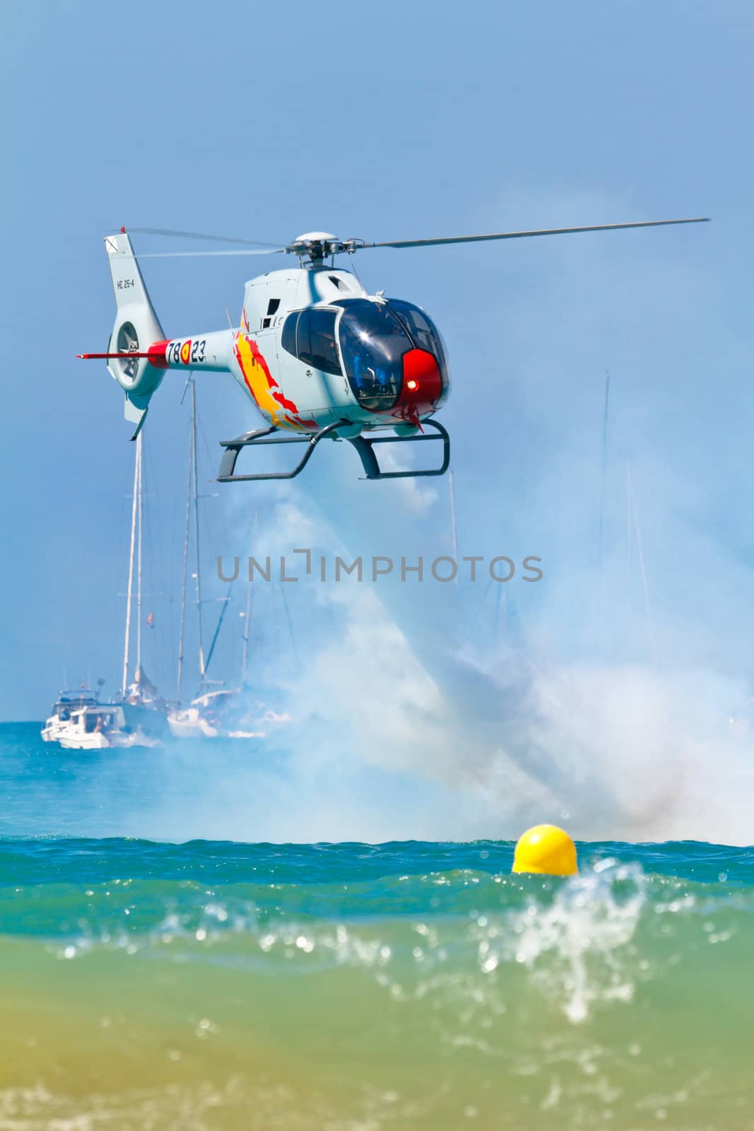 CADIZ, SPAIN-SEP 11: Helicopters of the Patrulla Aspa taking part in an exhibition on the 4th airshow of Cadiz on Sep 11, 2011, in Cadiz, Spain