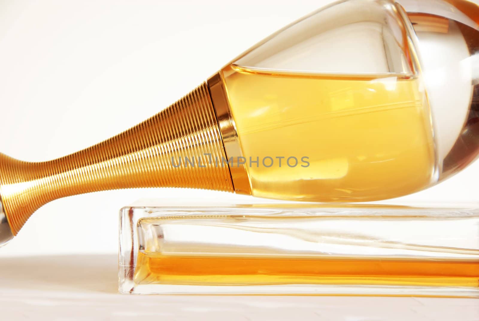 perfumes in glass bottles over white background