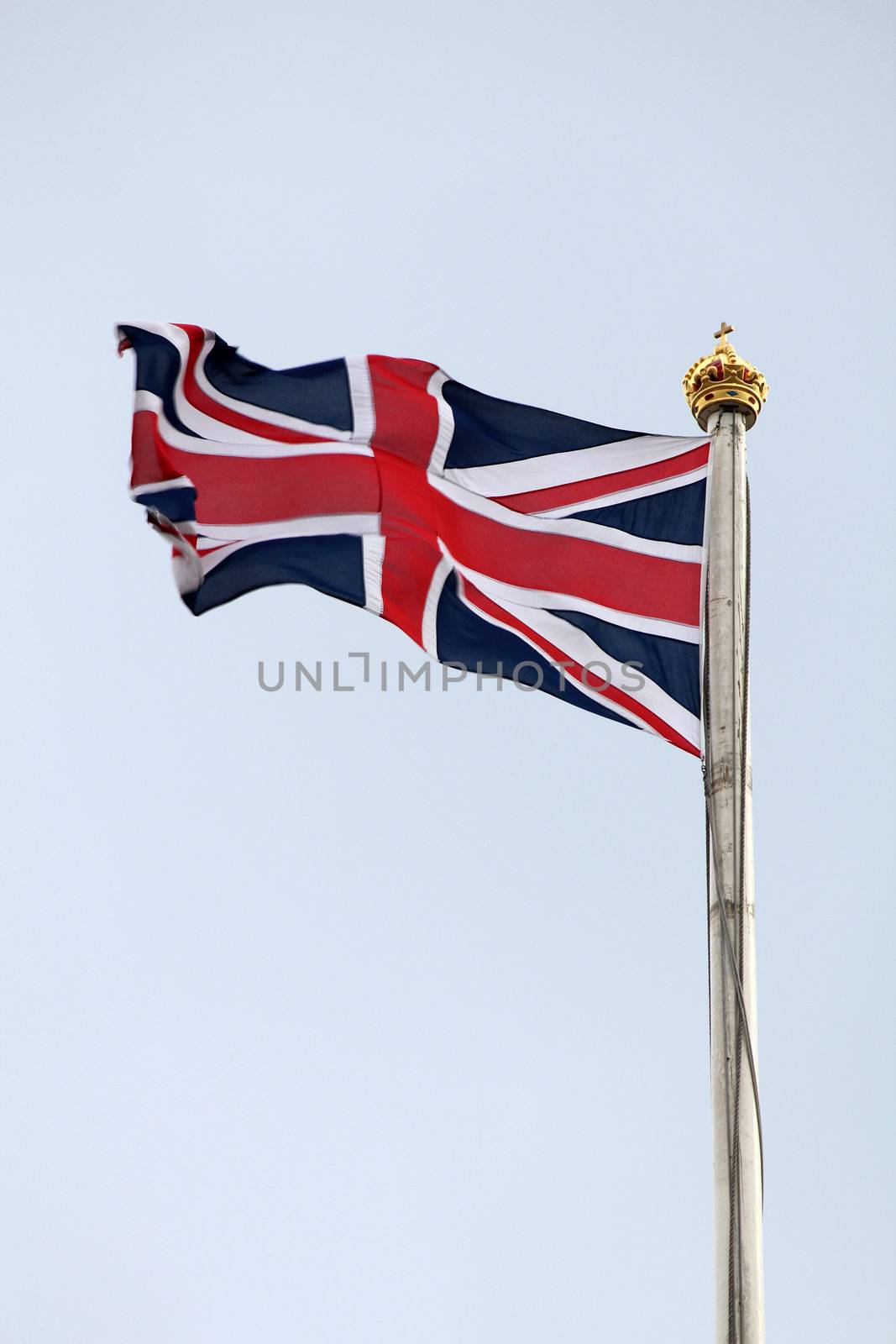British Flag on top of Bukingham Palace, with gold crown