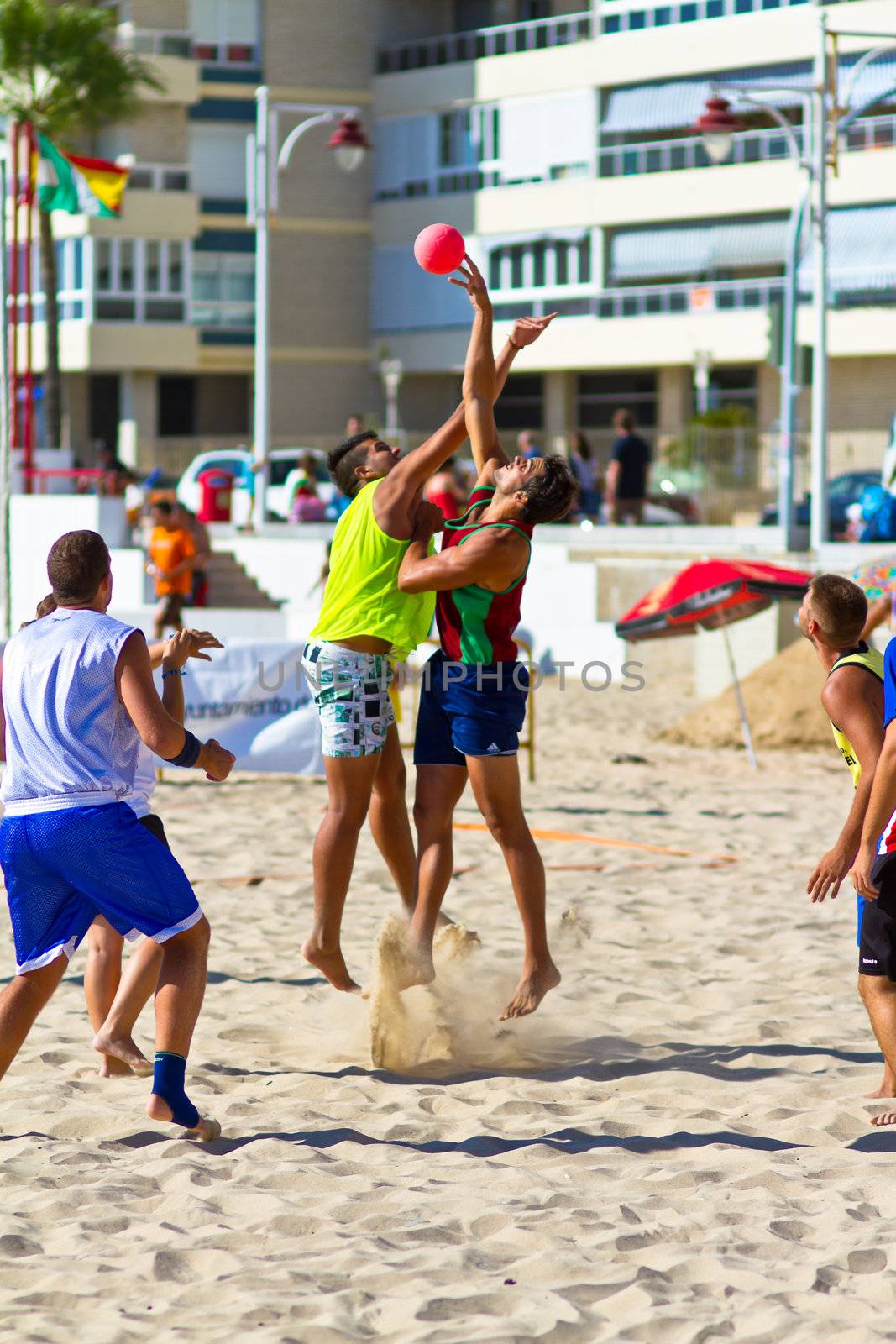 CADIZ, SPAIN - JULY 19: Unidentified players compete in a match between Los Negritos and Ademar Adentro in the 19th league of beach handball of Cadiz on July 19, 2011 in Cadiz, Spain