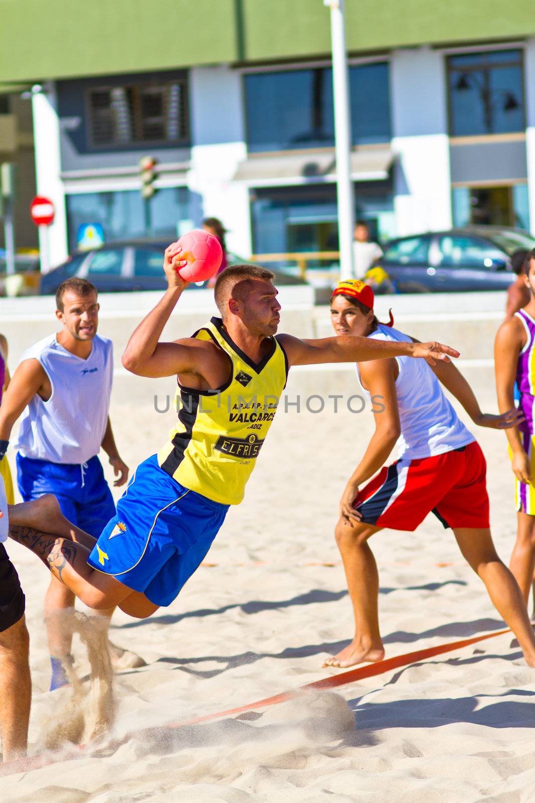CADIZ, SPAIN - JULY 19: Unidentified players compete in a match between Los Negritos and Ademar Adentro in the 19th league of beach handball of Cadiz on July 19, 2011 in Cadiz, Spain