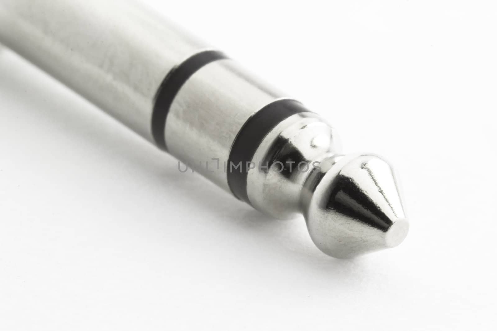 An silver colored audio connector isolated on a white background