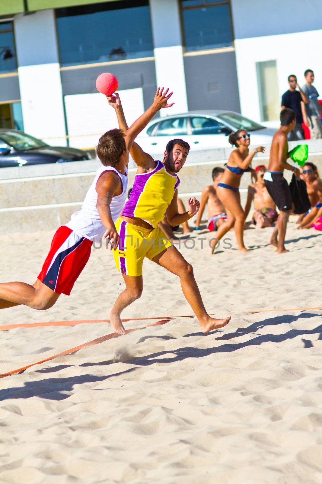 CADIZ, SPAIN - JULY 19: Unidentified players compete in a match between Los Negritos and Ademar Adentro in the 19th league of beach handball of Cadiz on July 19, 2011 in Cadiz, Spain