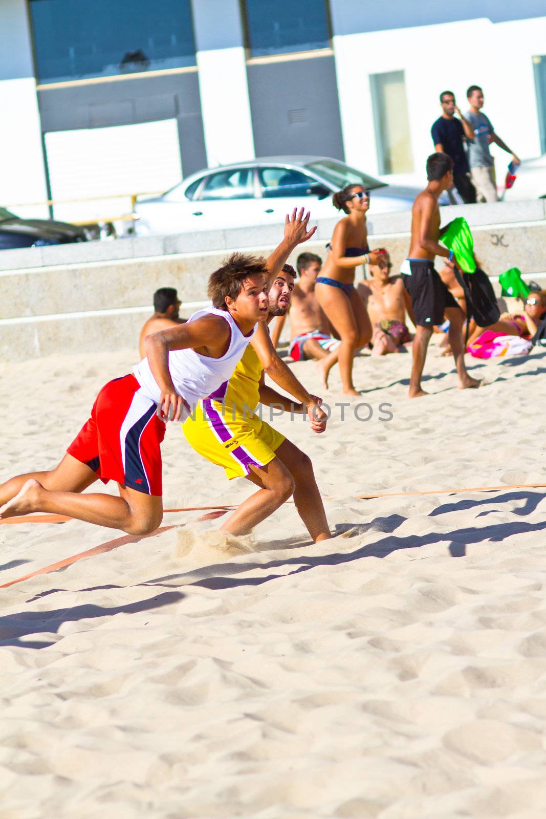 CADIZ, SPAIN - JULY 19: Unidentified players compete in a match between Los Negritos and Ademar Adentro in the 19th league of beach handball of Cadiz on July 19, 2011 in Cadiz, Spain