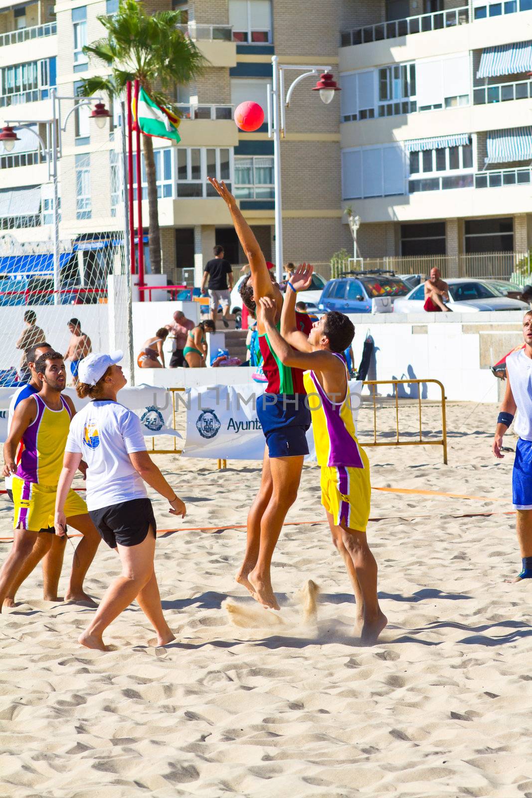 CADIZ, SPAIN - JULY 19: Unidentified players compete in a match between Los Negritos and Ademar Adentro in the 19th league of beach handball of Cadiz on July 19, 2011 in Cadiz, Spain