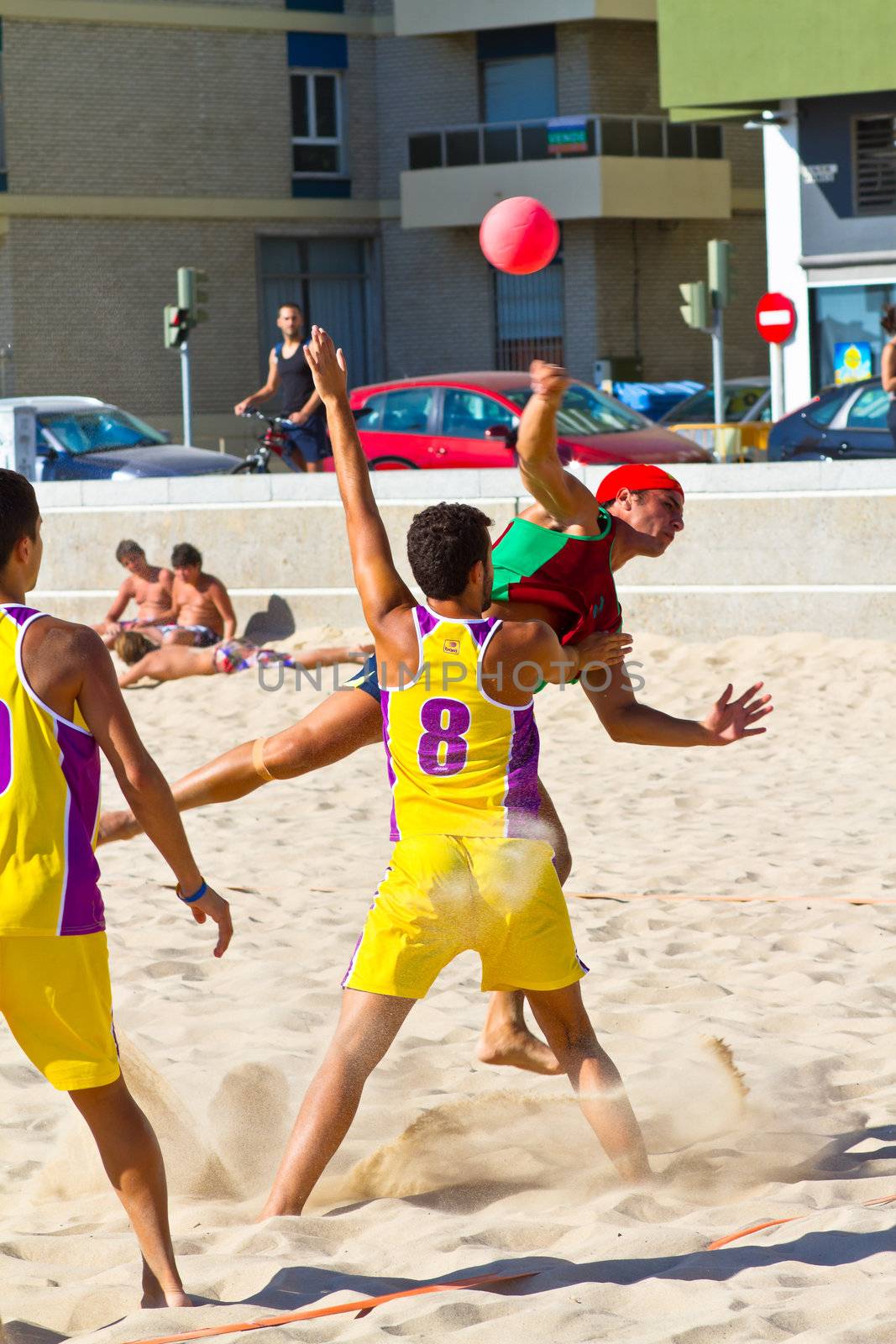 CADIZ, SPAIN - JULY 19: Unidentified players compete in a match between Los Negritos and Ademar Adentro in the 19th league of beach handball of Cadiz on July 19, 2011 in Cadiz, Spain