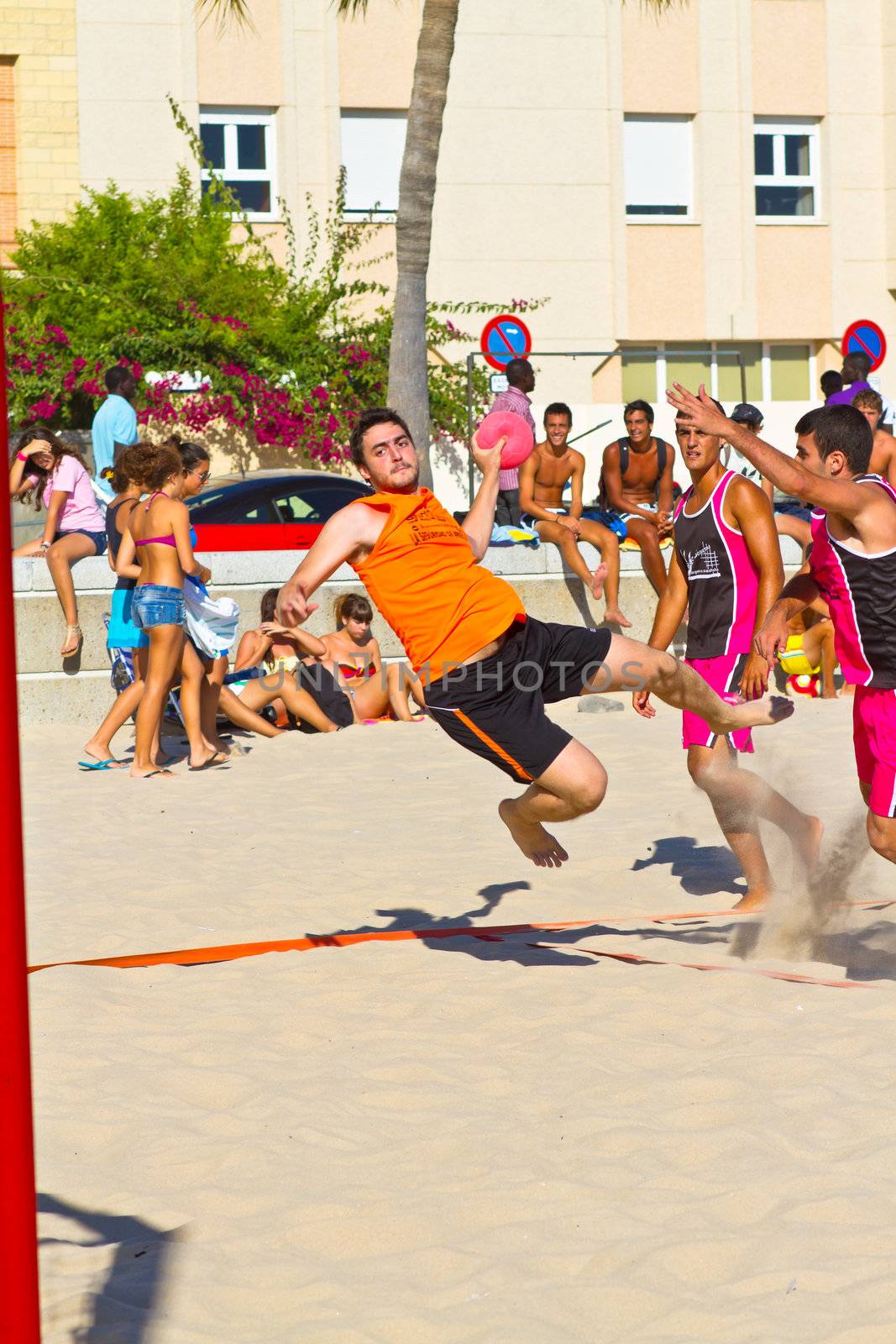 CADIZ, SPAIN - JULY 19: Unidentified players compete in a match between Autoescuela Barquin and CadizSur Seguros BMPY in the 19th league of beach handball of Cadiz on July 19, 2011 in Cadiz, Spain