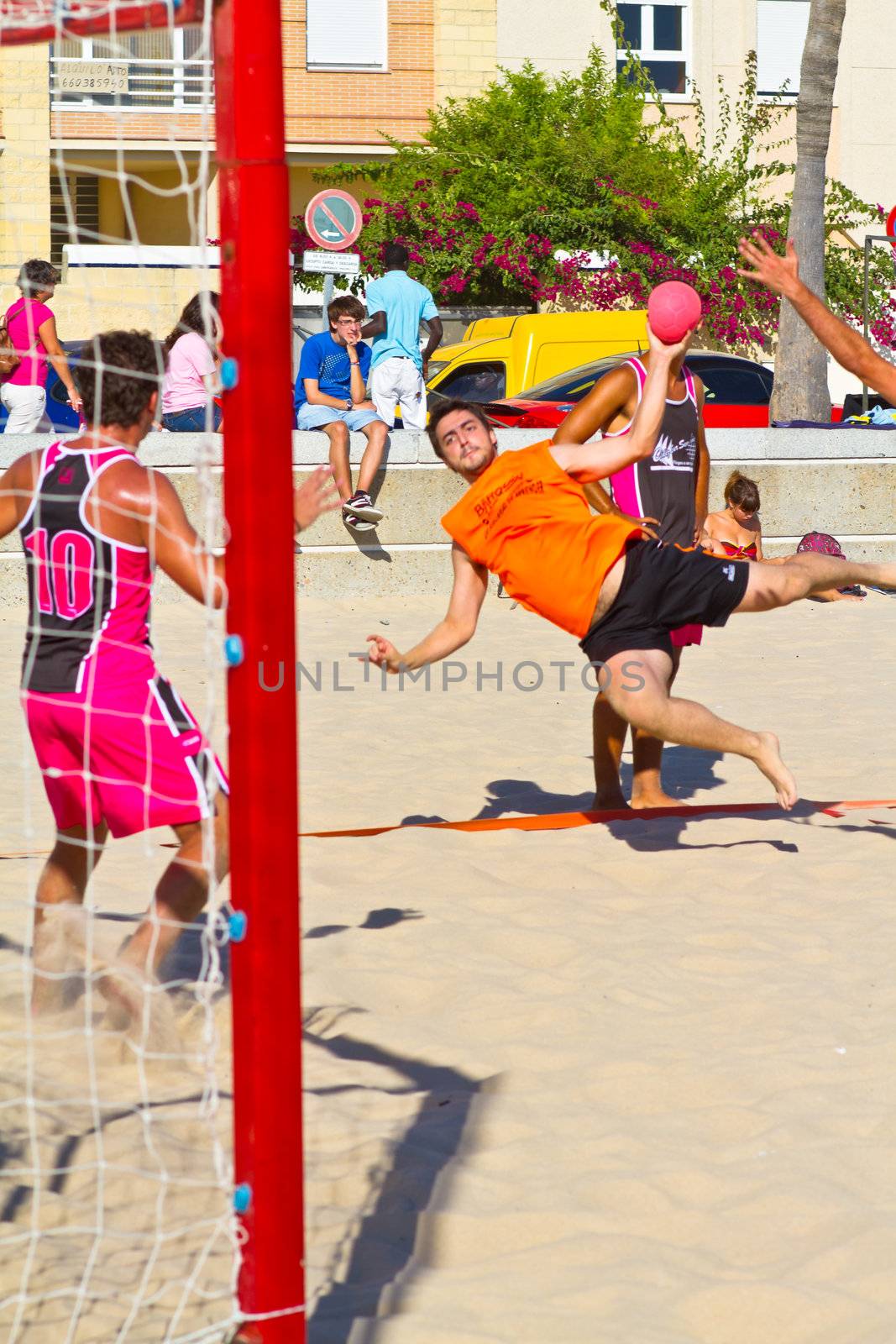 CADIZ, SPAIN - JULY 19: Unidentified players compete in a match between Autoescuela Barquin and CadizSur Seguros BMPY in the 19th league of beach handball of Cadiz on July 19, 2011 in Cadiz, Spain