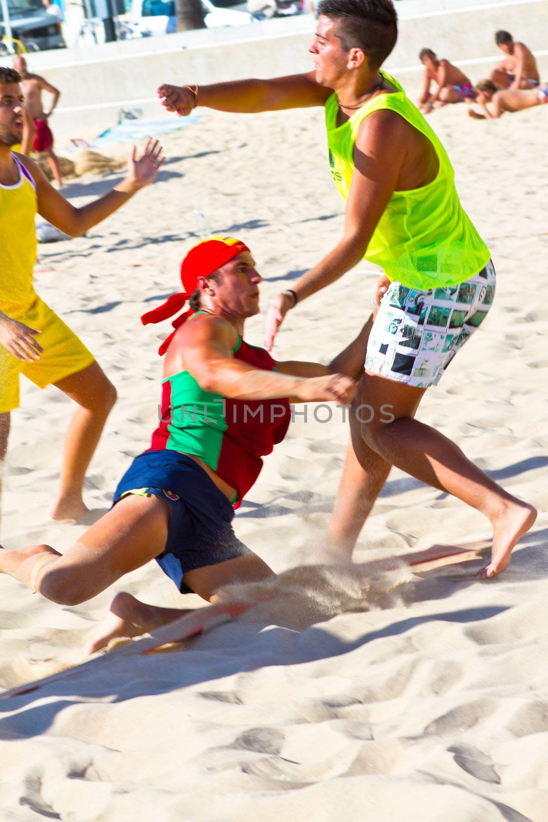 CADIZ, SPAIN - JULY 19: Unidentified players compete in a match between Los Negritos and Ademar Adentro in the 19th league of beach handball of Cadiz on July 19, 2011 in Cadiz, Spain