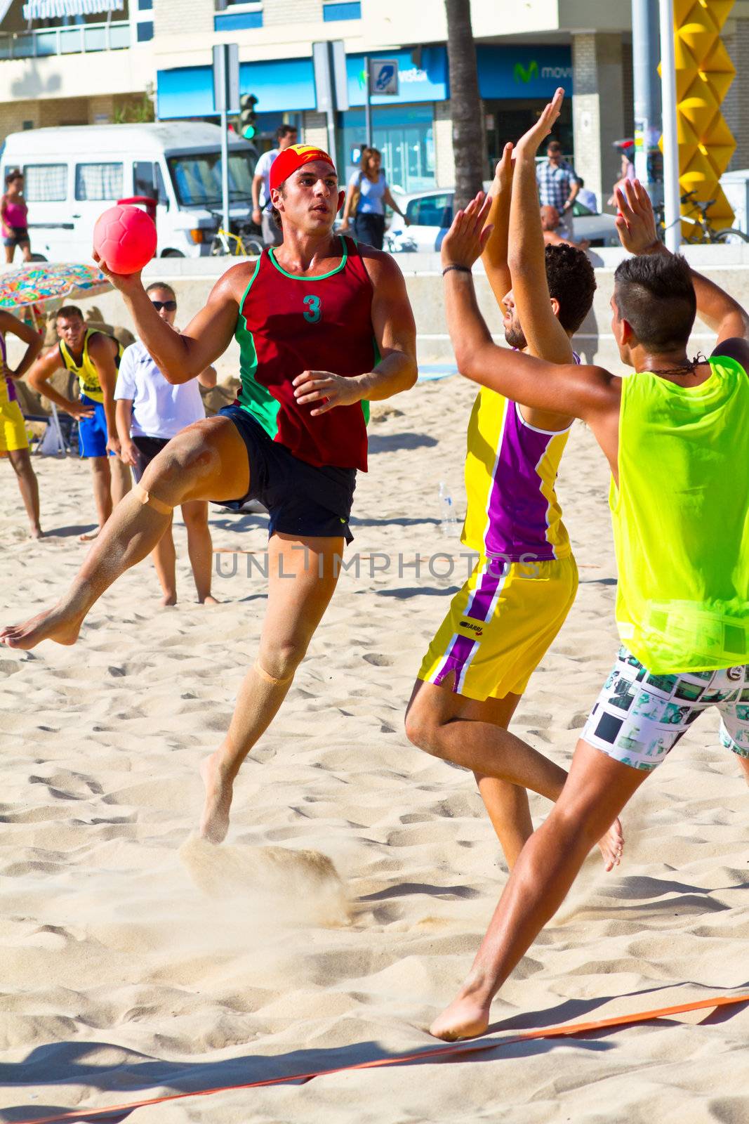 CADIZ, SPAIN - JULY 19: Unidentified players compete in a match between Los Negritos and Ademar Adentro in the 19th league of beach handball of Cadiz on July 19, 2011 in Cadiz, Spain