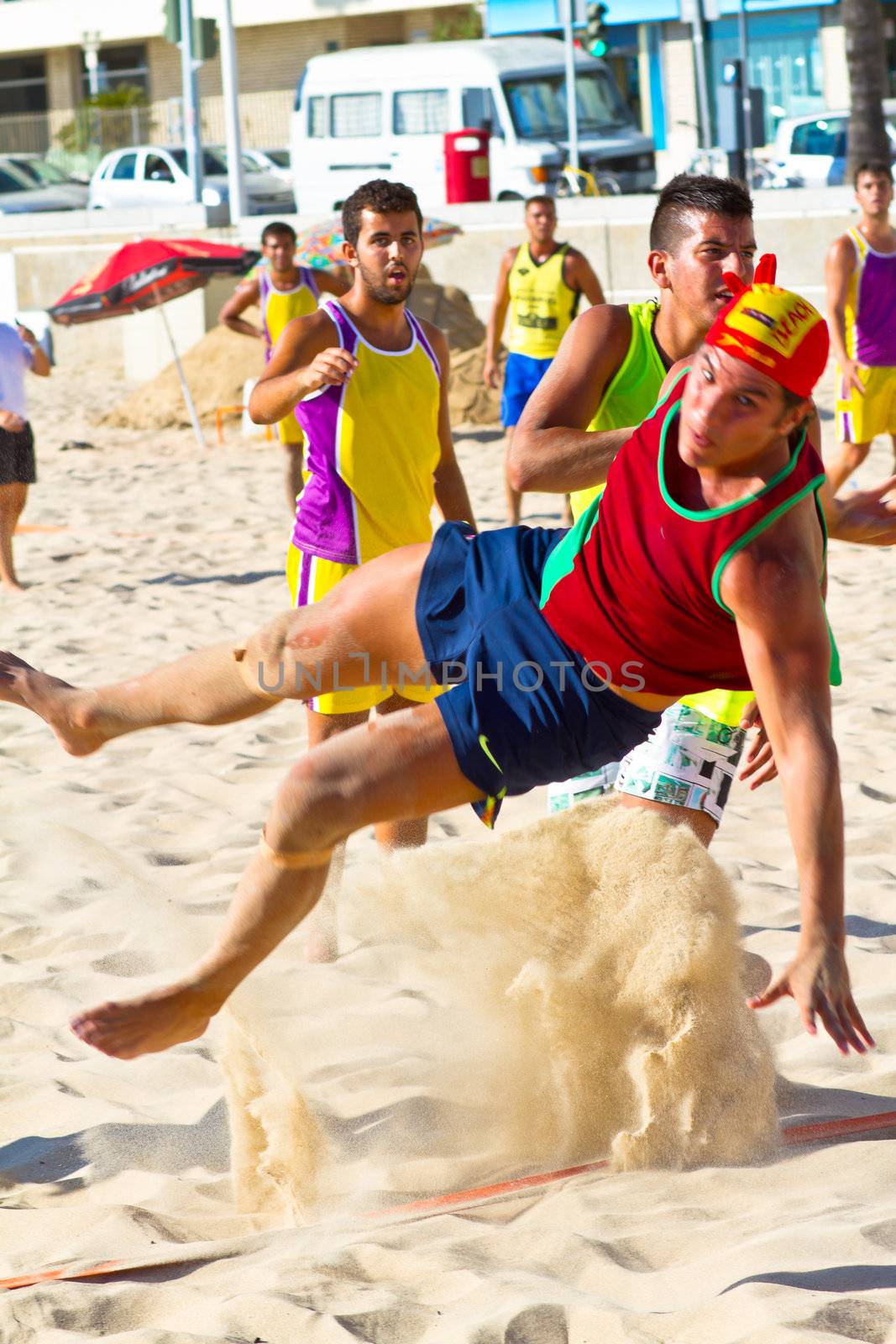 CADIZ, SPAIN - JULY 19: Unidentified players compete in a match between Los Negritos and Ademar Adentro in the 19th league of beach handball of Cadiz on July 19, 2011 in Cadiz, Spain