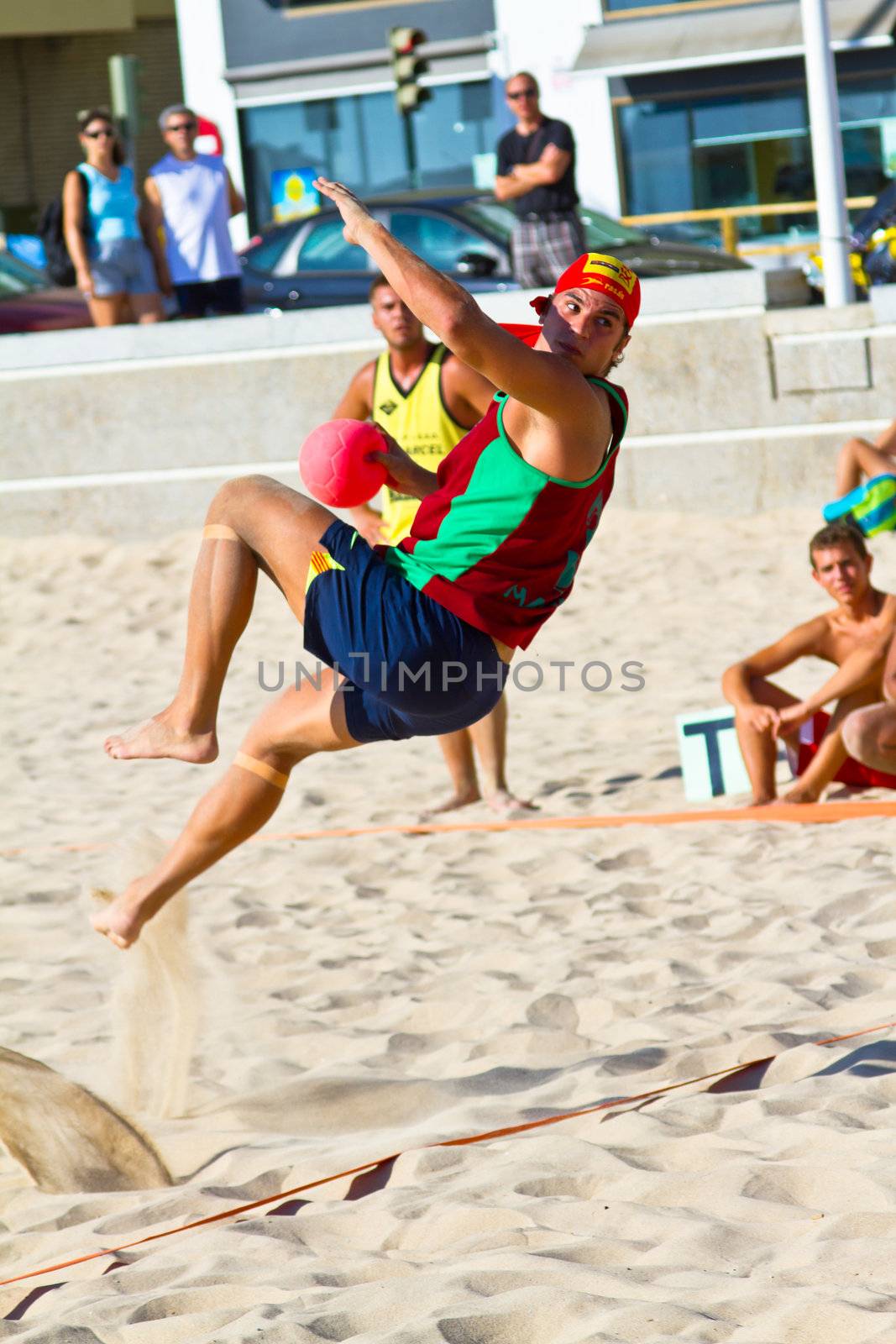 CADIZ, SPAIN - JULY 19: Unidentified players compete in a match between Los Negritos and Ademar Adentro in the 19th league of beach handball of Cadiz on July 19, 2011 in Cadiz, Spain