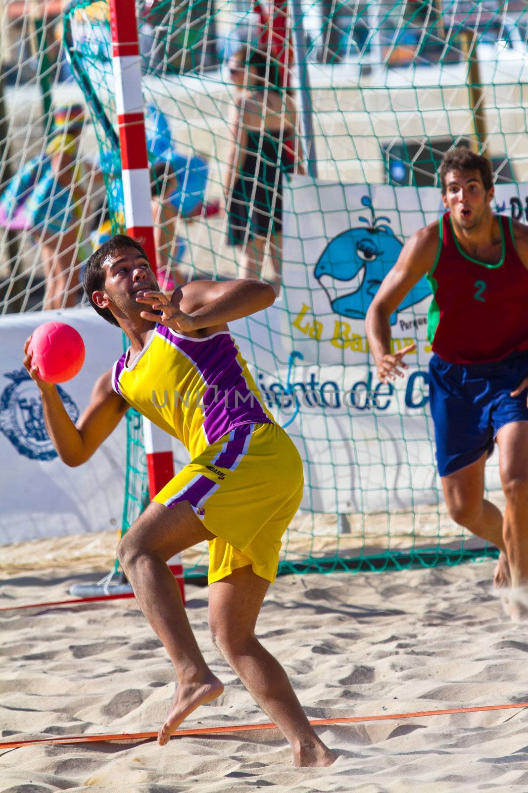 CADIZ, SPAIN - JULY 19: Unidentified players compete in a match between Los Negritos and Ademar Adentro in the 19th league of beach handball of Cadiz on July 19, 2011 in Cadiz, Spain