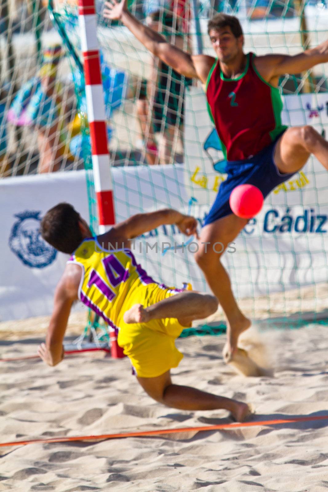 CADIZ, SPAIN - JULY 19: Unidentified players compete in a match between Los Negritos and Ademar Adentro in the 19th league of beach handball of Cadiz on July 19, 2011 in Cadiz, Spain