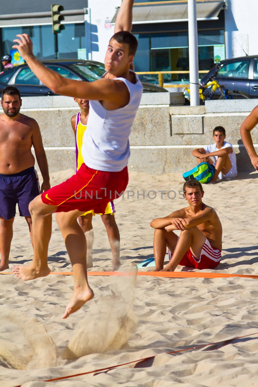CADIZ, SPAIN - JULY 19: Unidentified players compete in a match between Los Negritos and Ademar Adentro in the 19th league of beach handball of Cadiz on July 19, 2011 in Cadiz, Spain