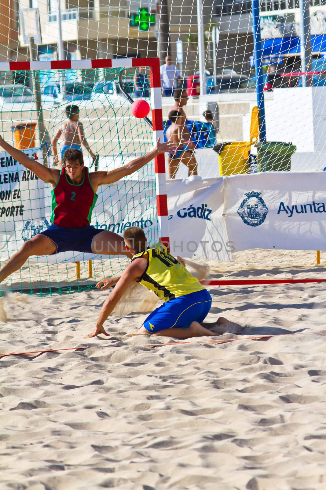 CADIZ, SPAIN - JULY 19: Unidentified players compete in a match between Los Negritos and Ademar Adentro in the 19th league of beach handball of Cadiz on July 19, 2011 in Cadiz, Spain