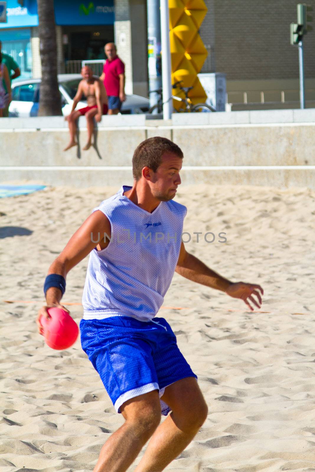CADIZ, SPAIN - JULY 19: Unidentified players compete in a match between Los Negritos and Ademar Adentro in the 19th league of beach handball of Cadiz on July 19, 2011 in Cadiz, Spain