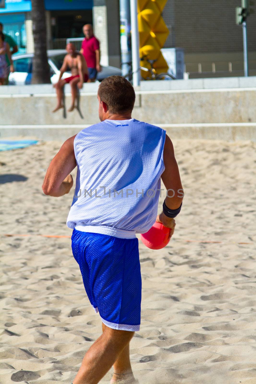 CADIZ, SPAIN - JULY 19: Unidentified players compete in a match between Los Negritos and Ademar Adentro in the 19th league of beach handball of Cadiz on July 19, 2011 in Cadiz, Spain