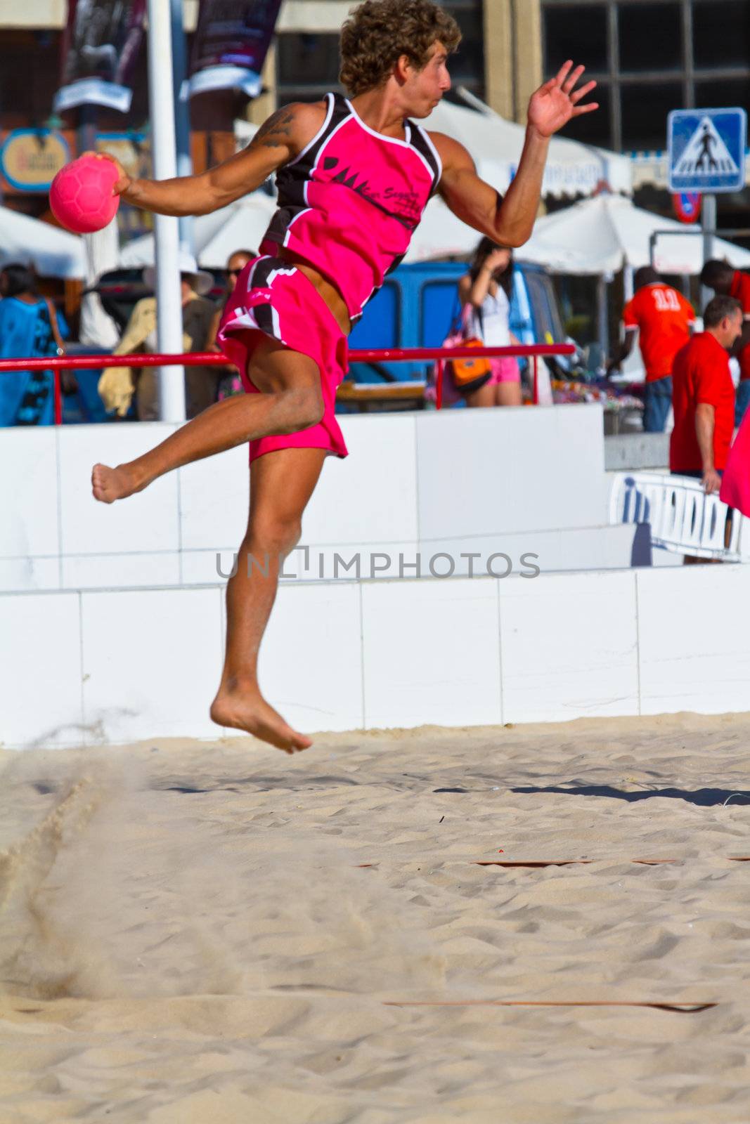 CADIZ, SPAIN - JULY 19: Unidentified players compete in a match between Autoescuela Barquin and CadizSur Seguros BMPY in the 19th league of beach handball of Cadiz on July 19, 2011 in Cadiz, Spain