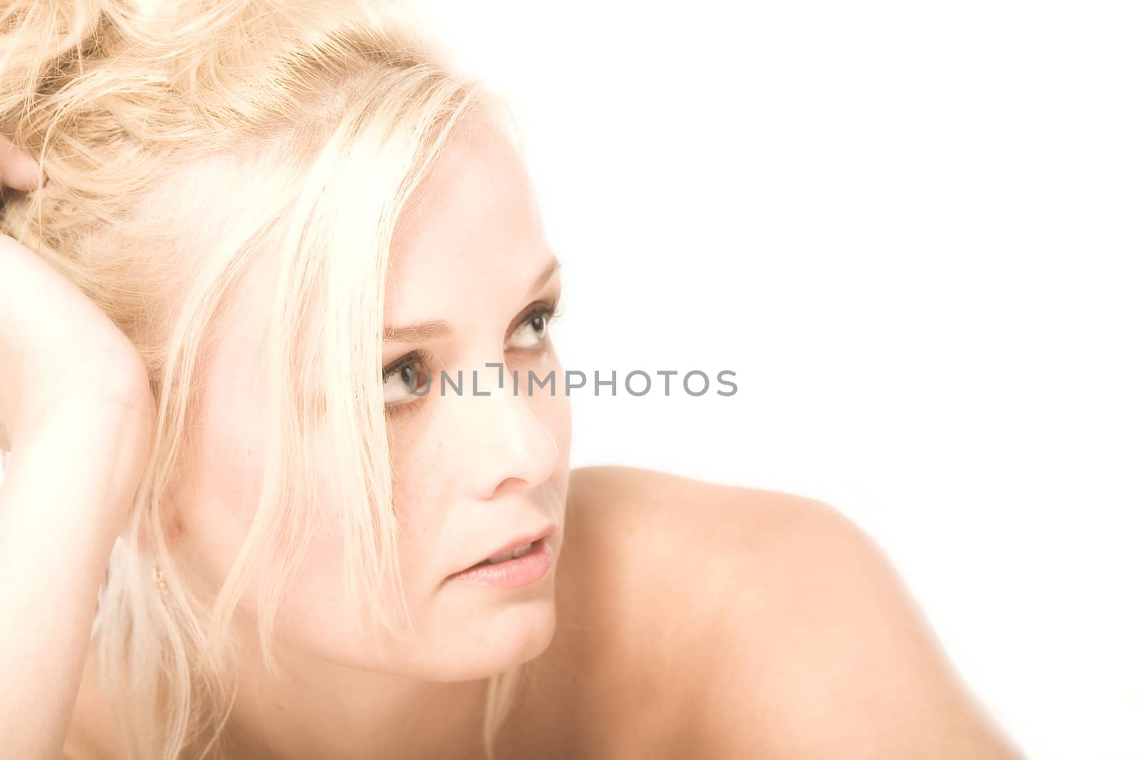 Portrait of a beautiful blond in the studio in thoughts
