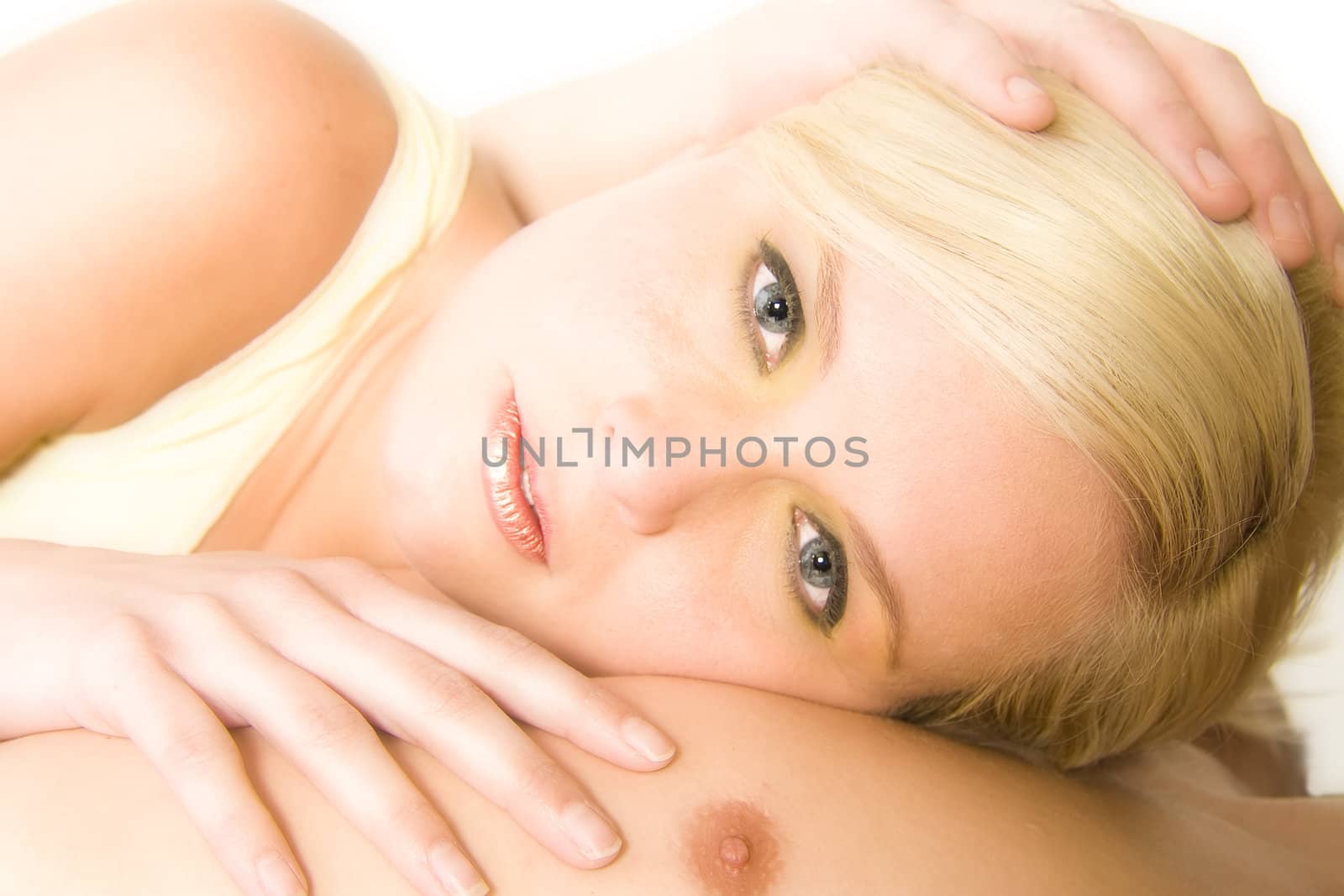 Portrait of a beautiful blond in the studio resting on het boyfriends chest