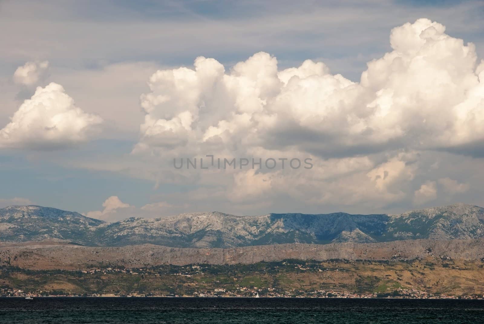 oversea View from Mediterranean island Brac to the land with cloud formation on the sky