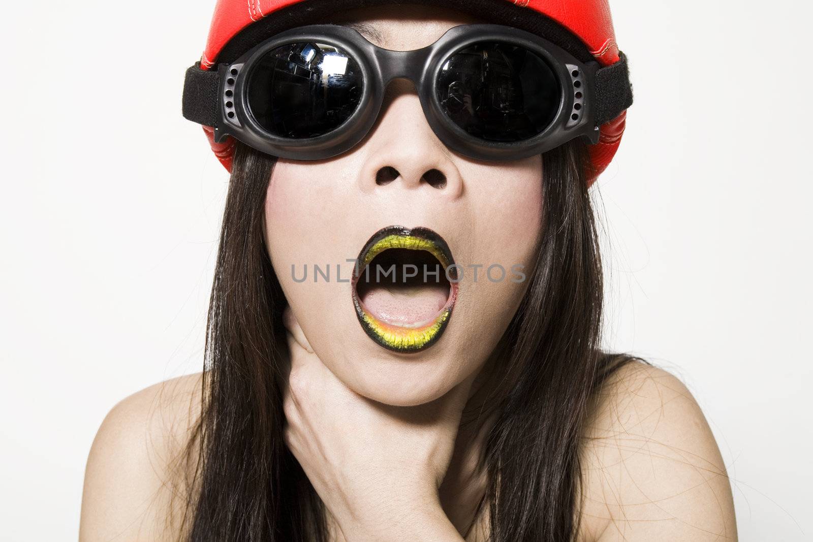 Studio portrait of a asian girl choking herself looking funny