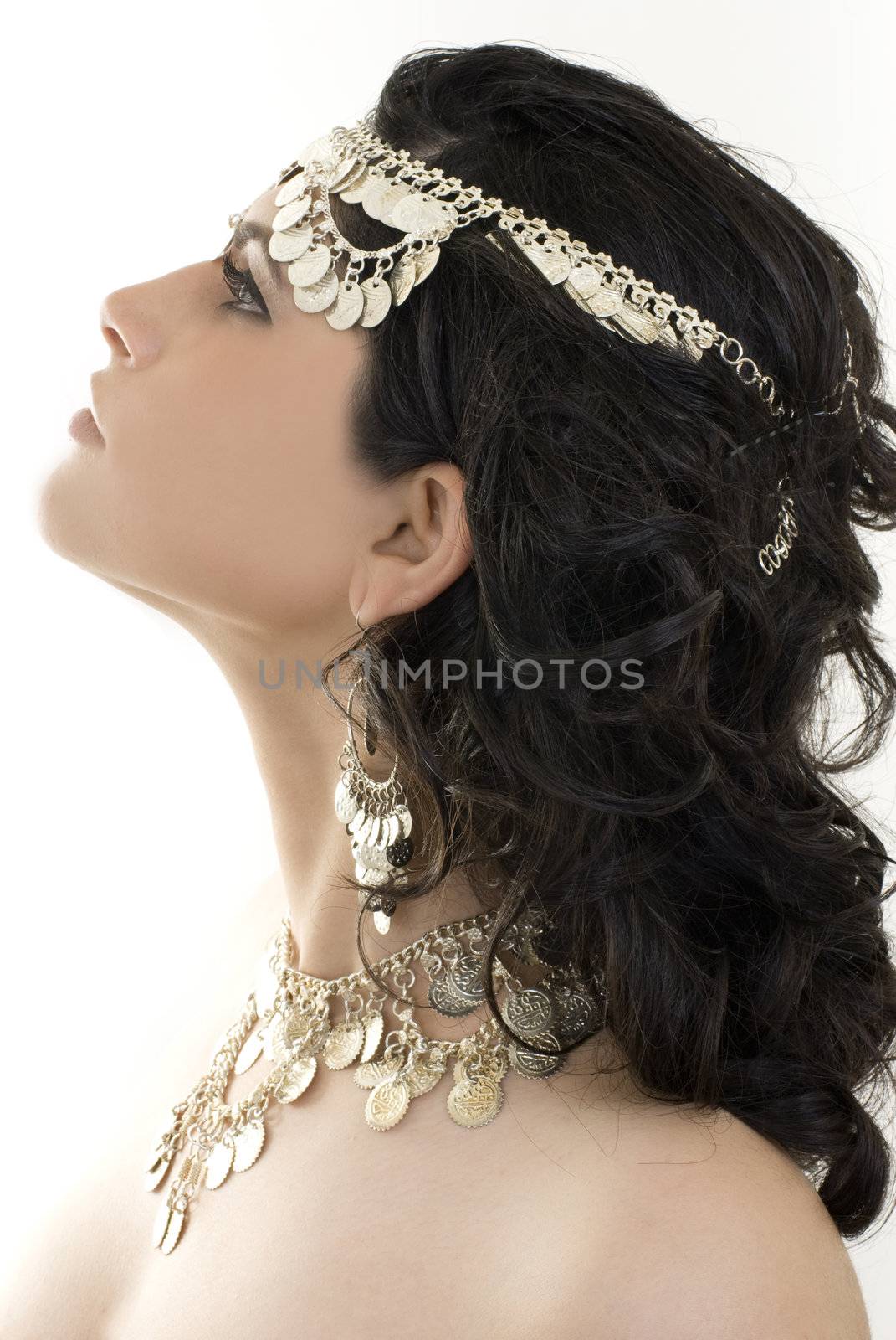 A young ethnic belly dancer isolated on a white background. 