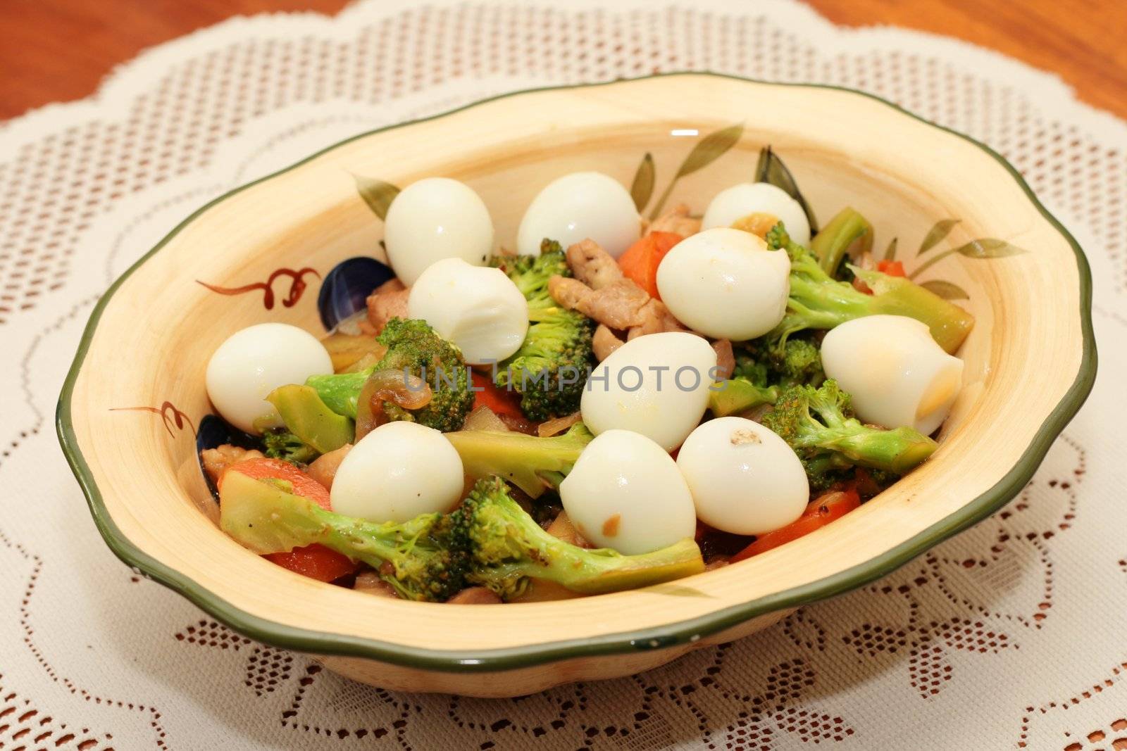 broccoli with quail eggs served in a bowl
