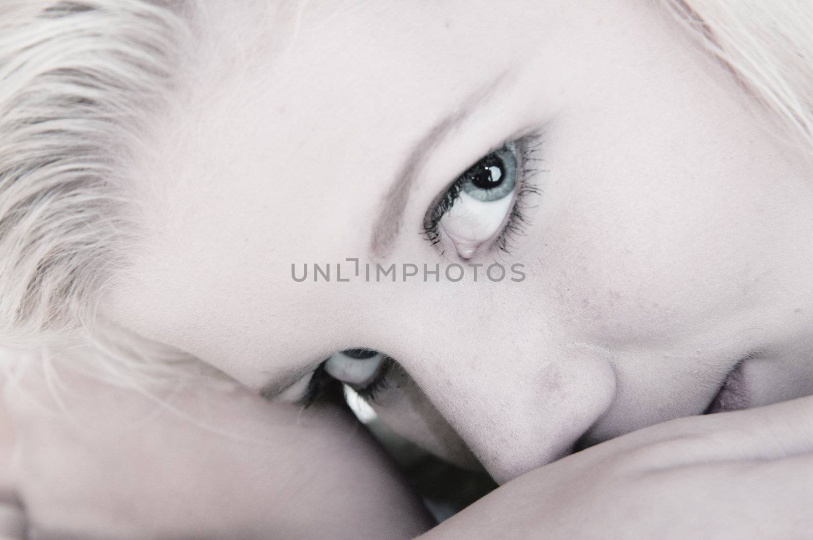 Studio portrait of a blond young lady looking dreamy