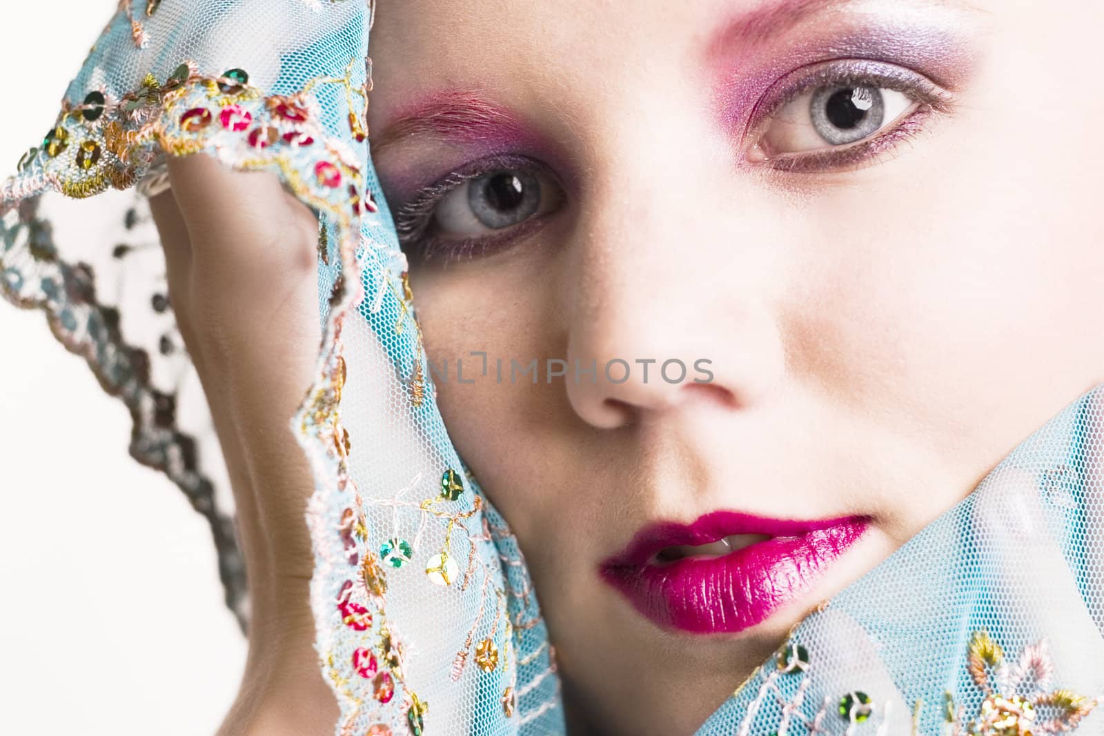 Studio portrait of a blond young lady enjoying silk