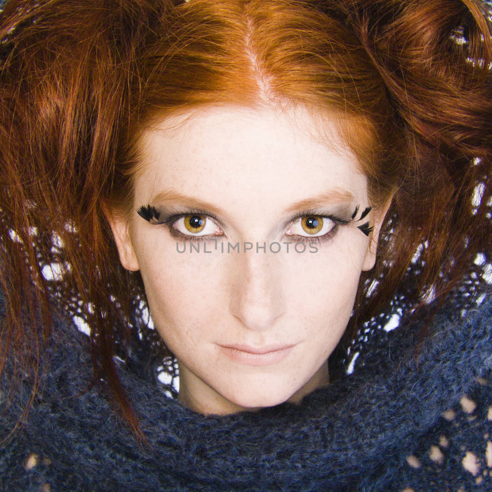 Studio portrait of a natural redhead with a blue sweater