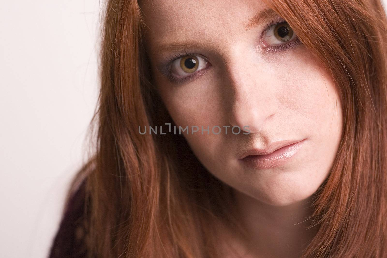 Studio portrait of a natural redhead looking thoughtful