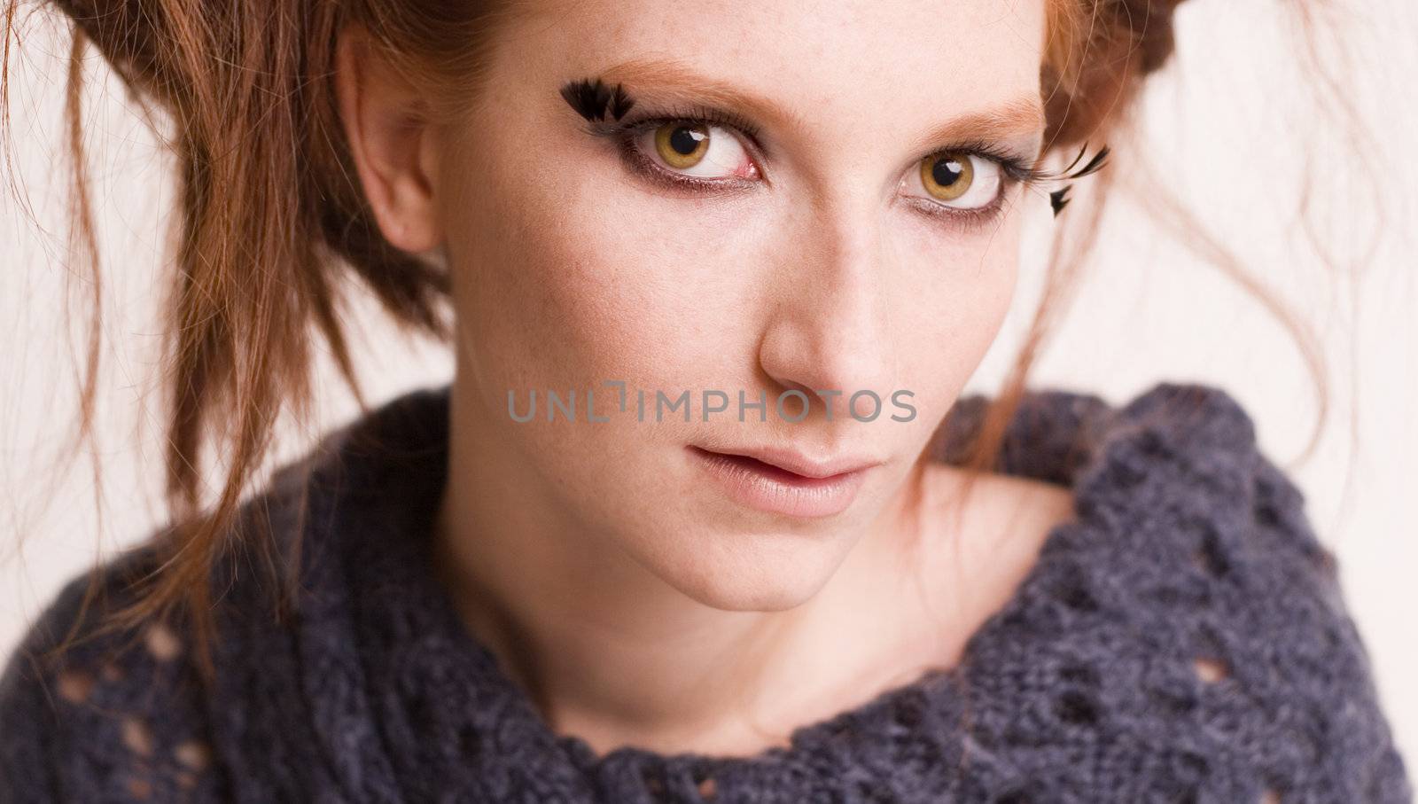 Studio portrait of a natural redhead with hypnotic green eyes