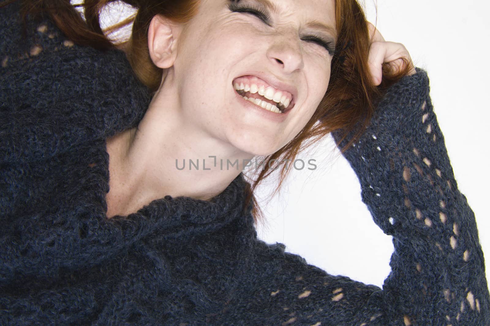 Studio portrait of a natural redhead looking agonised