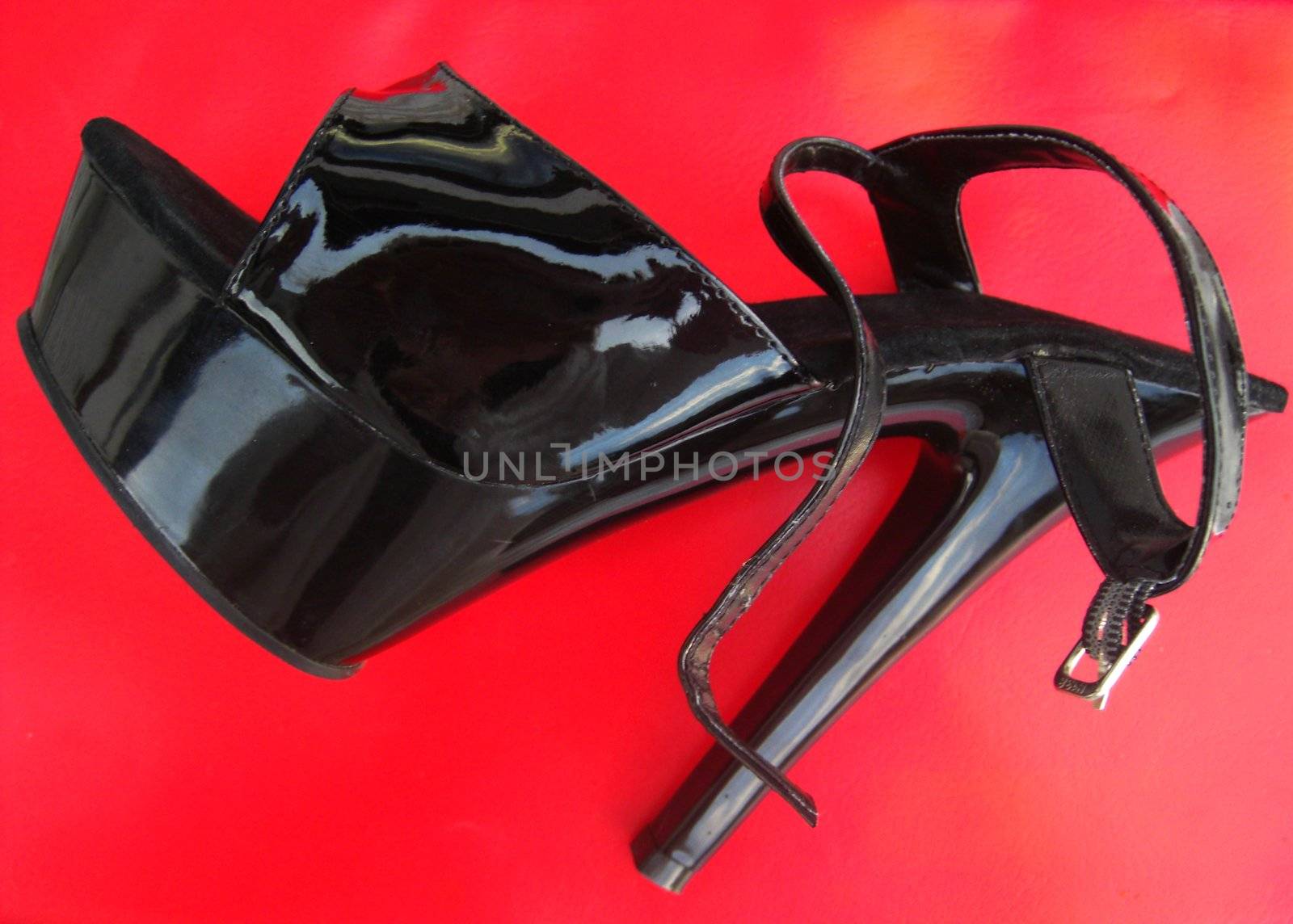 stiletto-heeled shoe made of patent leather, single object