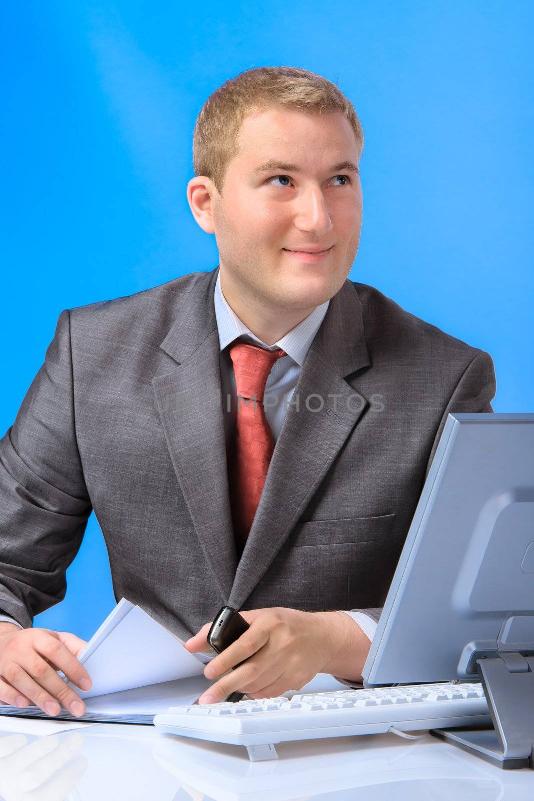 Young successful business man with a document case and computer