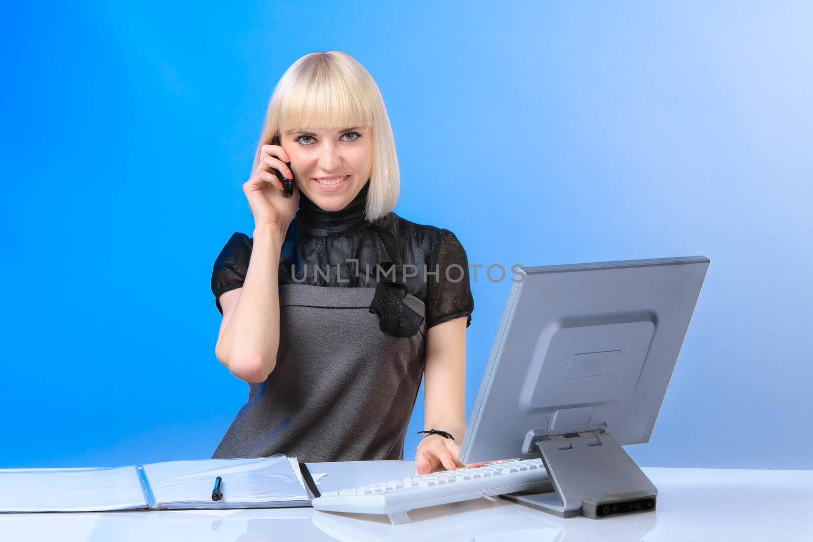 Beautiful young girl in a business clothes working in the office