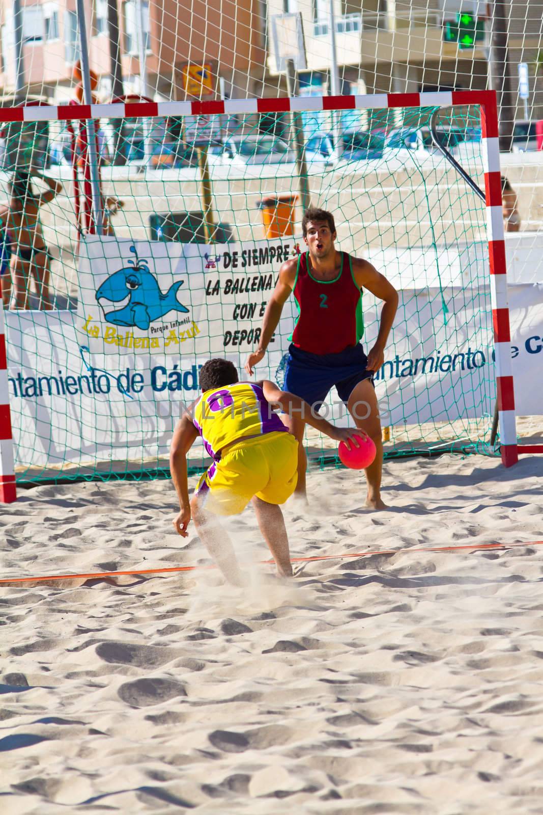 CADIZ, SPAIN - JULY 19: Unidentified players compete in a match between Los Negritos and Ademar Adentro in the 19th league of beach handball of Cadiz on July 19, 2011 in Cadiz, Spain