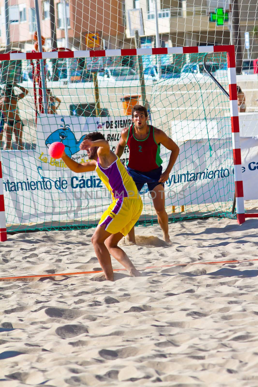 CADIZ, SPAIN - JULY 19: Unidentified players compete in a match between Los Negritos and Ademar Adentro in the 19th league of beach handball of Cadiz on July 19, 2011 in Cadiz, Spain