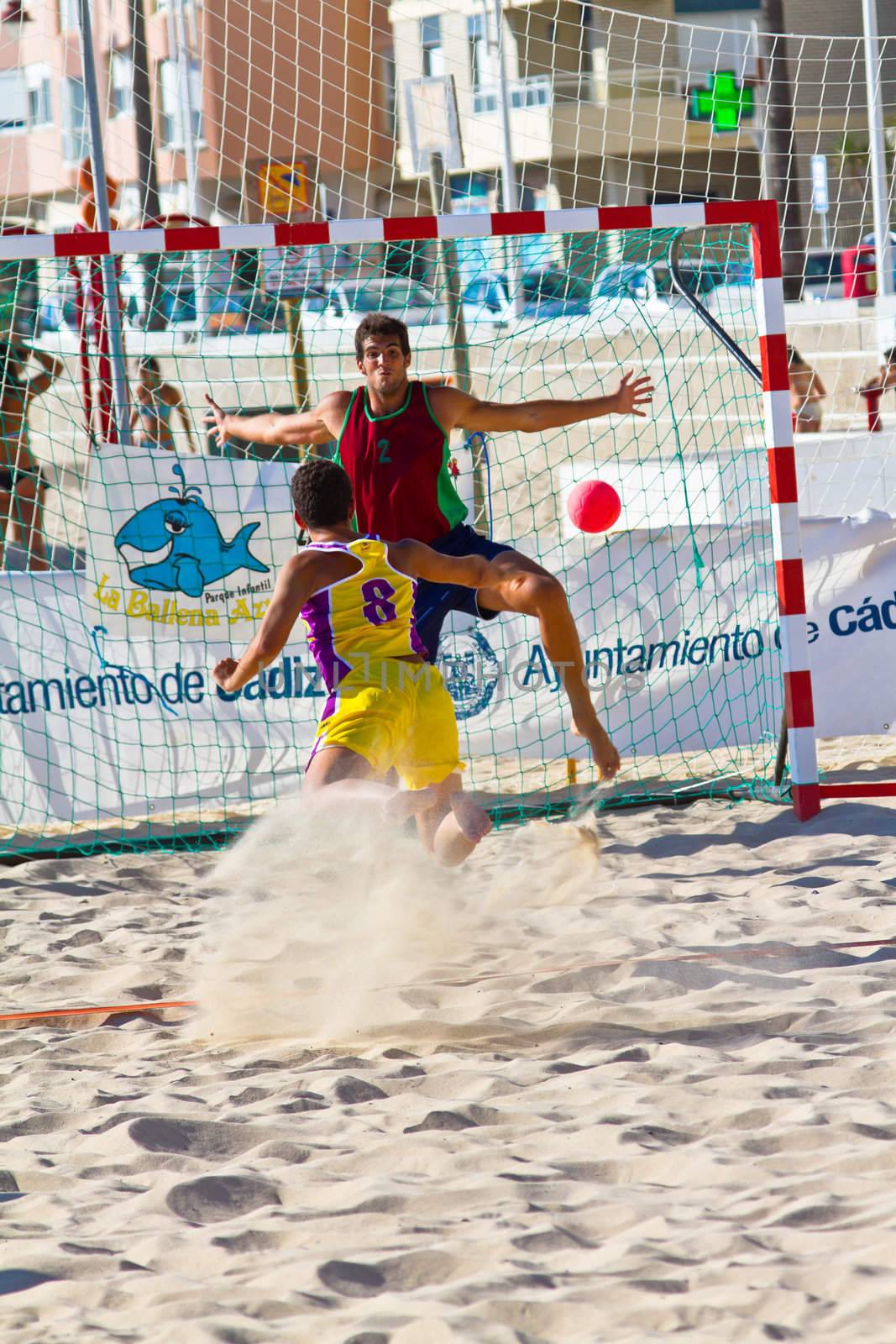 CADIZ, SPAIN - JULY 19: Unidentified players compete in a match between Los Negritos and Ademar Adentro in the 19th league of beach handball of Cadiz on July 19, 2011 in Cadiz, Spain