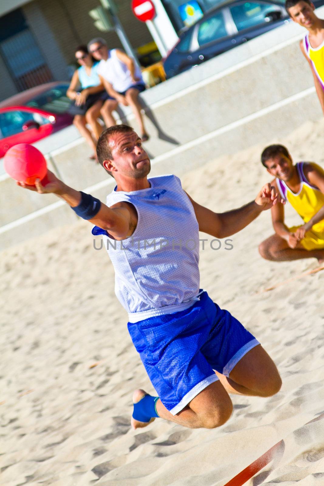 CADIZ, SPAIN - JULY 19: Unidentified players compete in a match between Los Negritos and Ademar Adentro in the 19th league of beach handball of Cadiz on July 19, 2011 in Cadiz, Spain