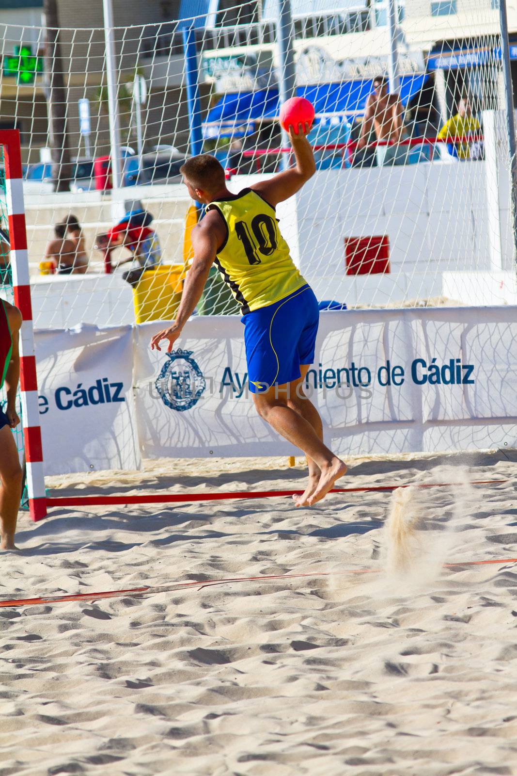 CADIZ, SPAIN - JULY 19: Unidentified players compete in a match between Los Negritos and Ademar Adentro in the 19th league of beach handball of Cadiz on July 19, 2011 in Cadiz, Spain
