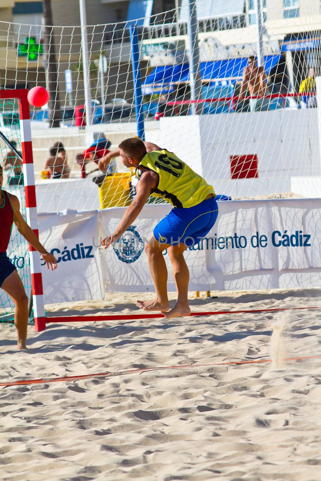 CADIZ, SPAIN - JULY 19: Unidentified players compete in a match between Los Negritos and Ademar Adentro in the 19th league of beach handball of Cadiz on July 19, 2011 in Cadiz, Spain