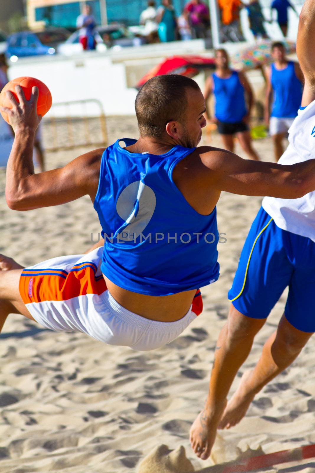 CADIZ, SPAIN - JULY 19: Unidentified players compete in a match between Valcarcel Recuperado and DecoHogar in the 19th league of beach handball of Cadiz on July 19, 2011 in Cadiz, Spain