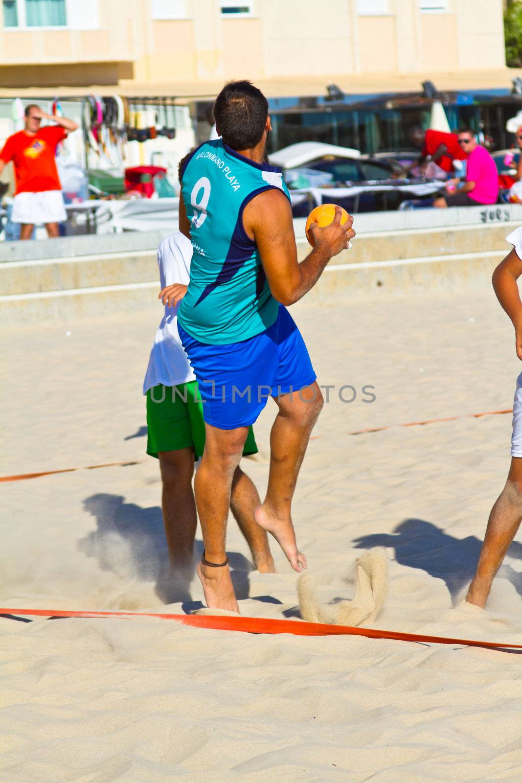 CADIZ, SPAIN - JULY 19: Unidentified players compete in a match between BMPY LAM Chiclana and Los Legendarios in the 19th league of beach handball of Cadiz on July 19, 2011 in Cadiz, Spain