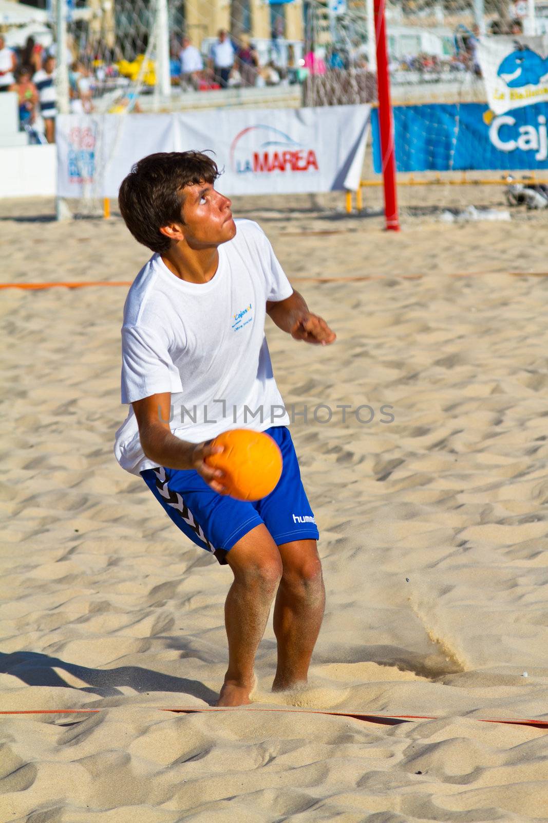 CADIZ, SPAIN - JULY 19: Unidentified players compete in a match between BMPY LAM Chiclana and Los Legendarios in the 19th league of beach handball of Cadiz on July 19, 2011 in Cadiz, Spain