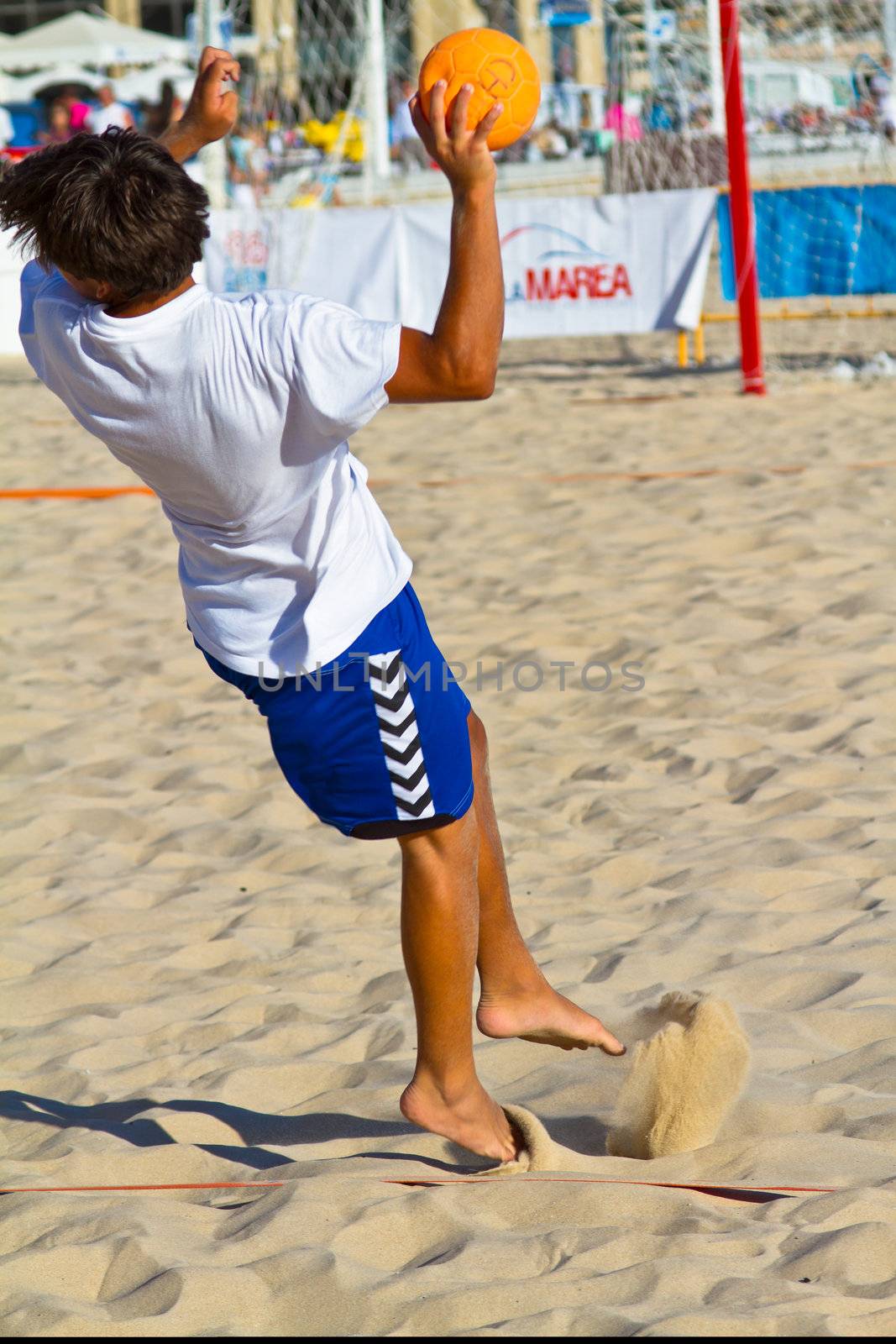 CADIZ, SPAIN - JULY 19: Unidentified players compete in a match between BMPY LAM Chiclana and Los Legendarios in the 19th league of beach handball of Cadiz on July 19, 2011 in Cadiz, Spain