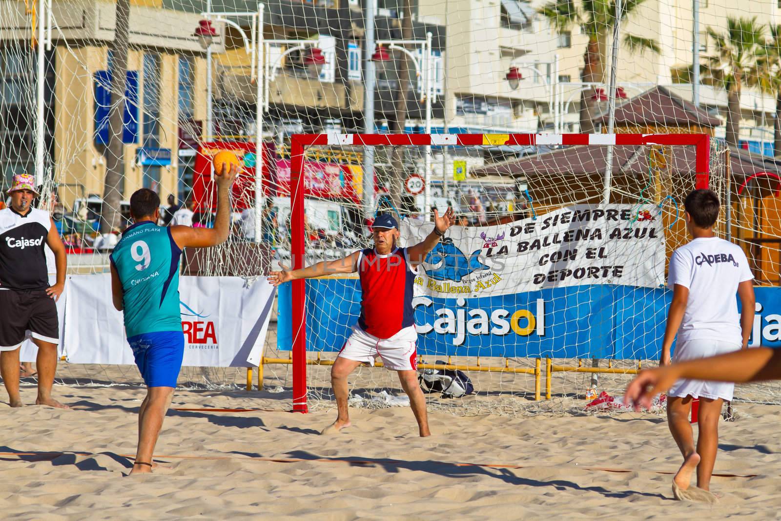CADIZ, SPAIN - JULY 19: Unidentified players compete in a match between BMPY LAM Chiclana and Los Legendarios in the 19th league of beach handball of Cadiz on July 19, 2011 in Cadiz, Spain